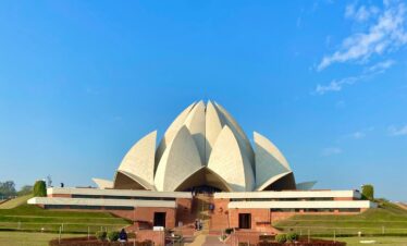 a large white building with a long walkway in front of it
