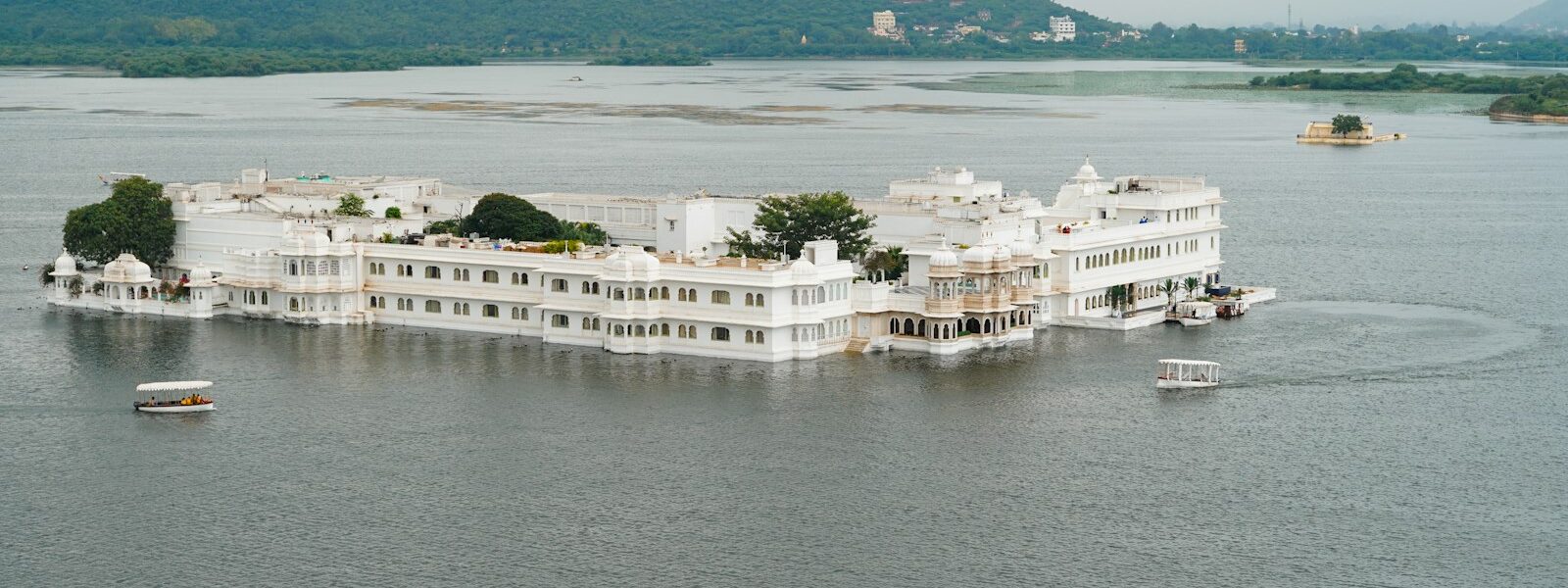 a large white building sitting on top of a lake