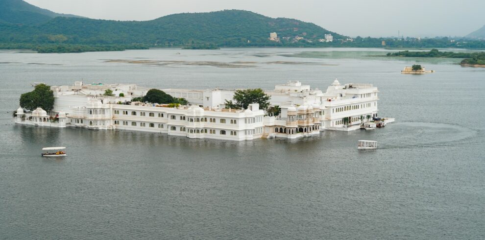 a large white building sitting on top of a lake