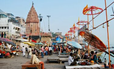 people sitting on bench near brown concrete building during daytime