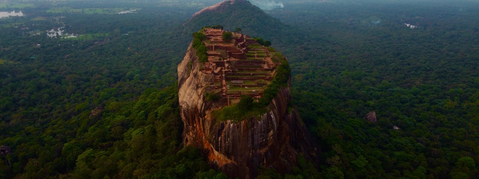 brown rock formation under white sky during daytime
