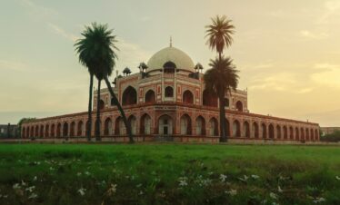 a large building with palm trees in front of it