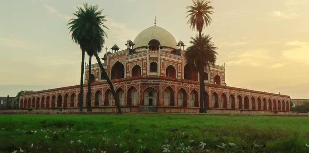 a large building with palm trees in front of it