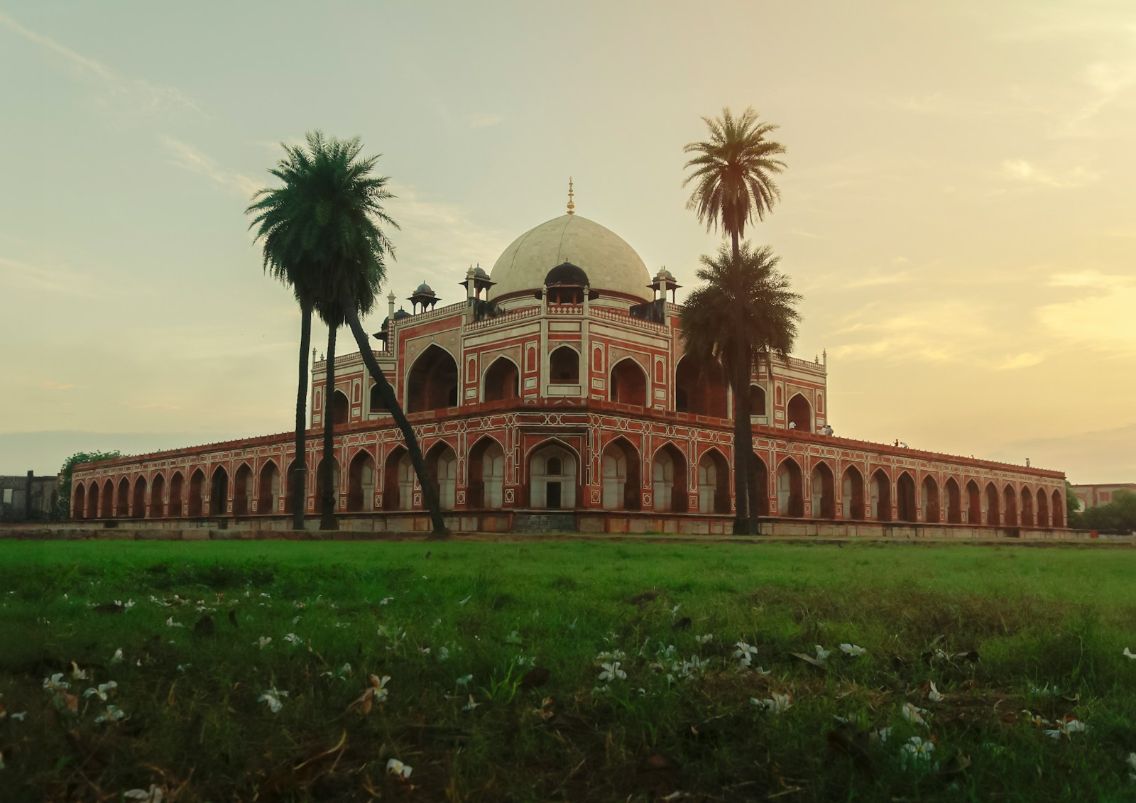 a large building with palm trees in front of it
