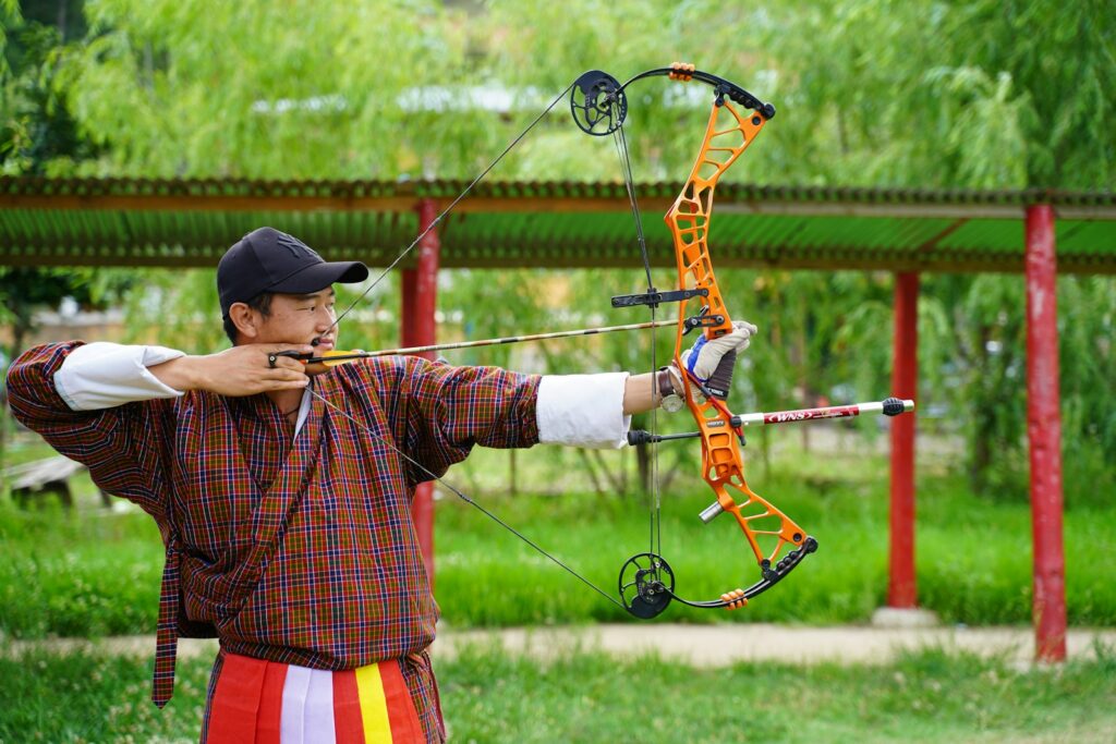 a man is holding a bow and aiming it