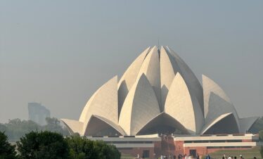 a group of people walking around a large building