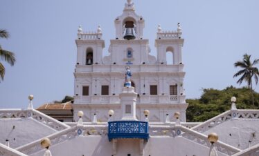 a white church with a cross on the top of it