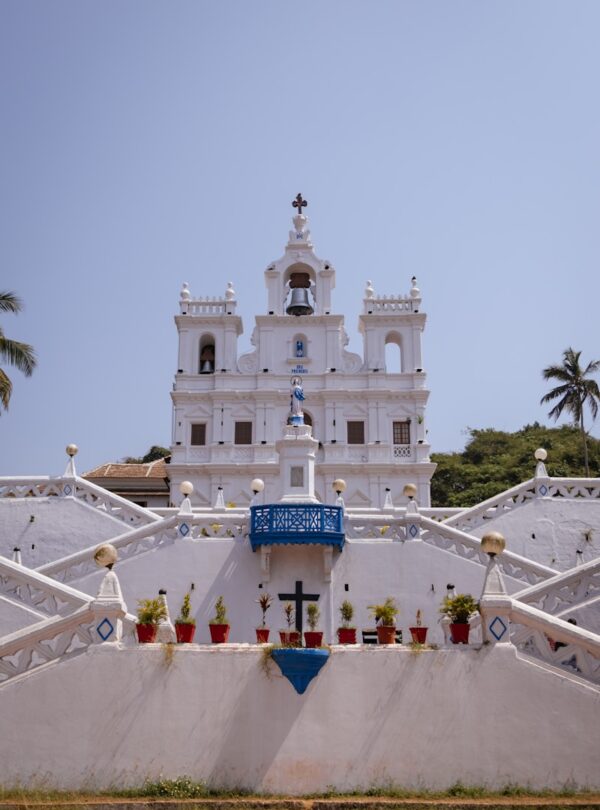 a white church with a cross on the top of it