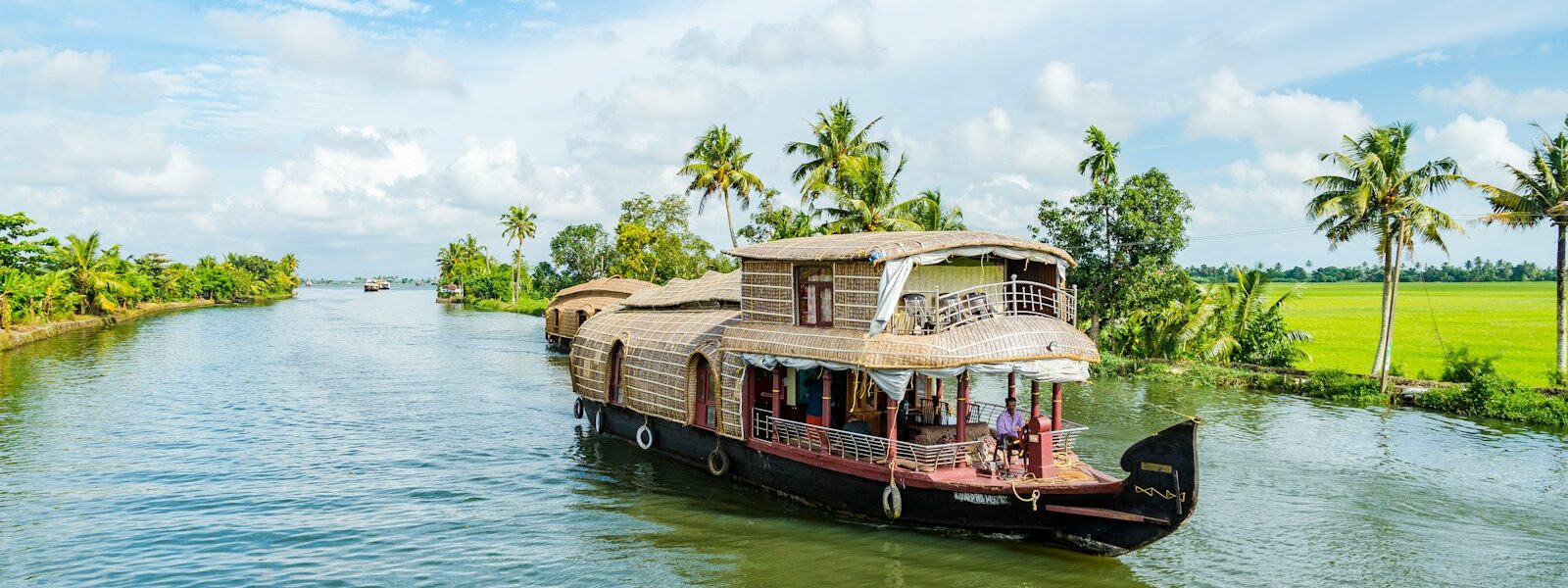 brown wooden boat on body of water during daytime