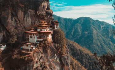 Paro Taktsang temple in Bhutan viewing mountain under blue and white sky